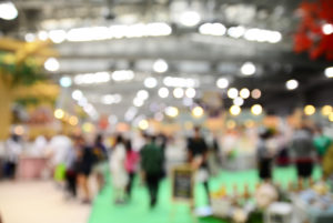Blurred image of people walking in a trade show.